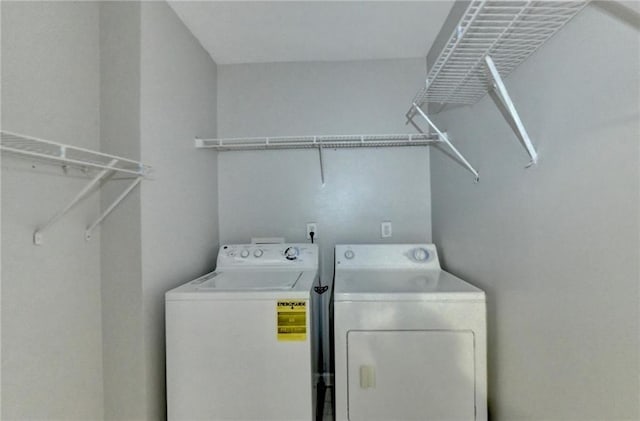 clothes washing area with washer and dryer and laundry area