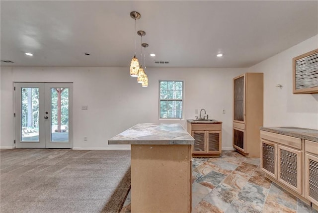 kitchen with french doors, recessed lighting, visible vents, a sink, and baseboards