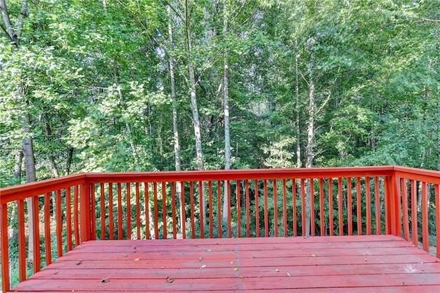 wooden deck featuring a view of trees