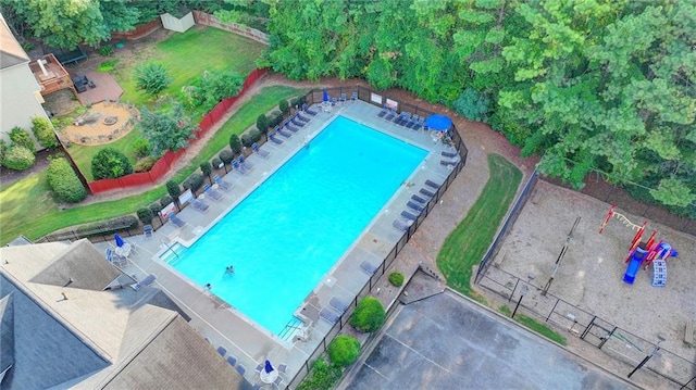 view of swimming pool featuring fence