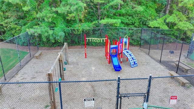 community jungle gym with a gate and fence