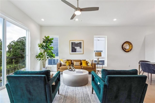 living room with ceiling fan and light hardwood / wood-style floors