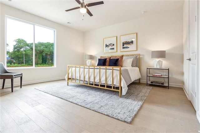 bedroom with light hardwood / wood-style flooring and ceiling fan