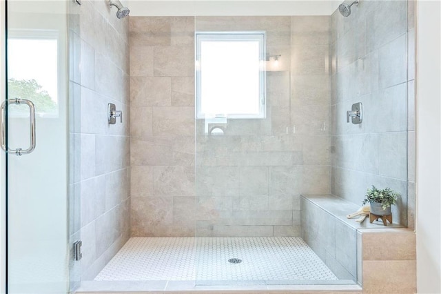 bathroom featuring walk in shower and a wealth of natural light