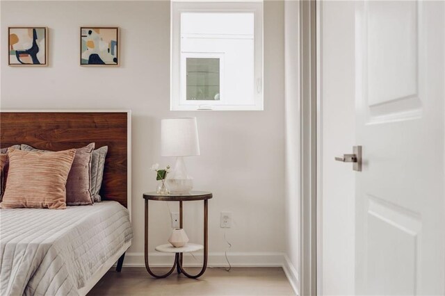 bedroom with hardwood / wood-style floors