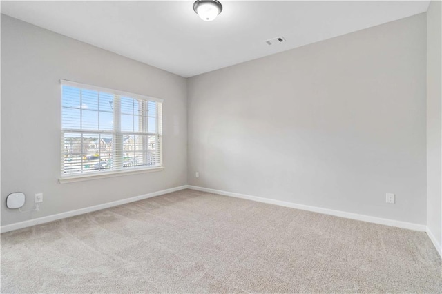 unfurnished room with light colored carpet