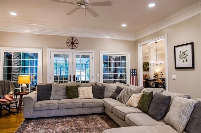 living area with a chandelier, ornamental molding, ceiling fan, recessed lighting, and wood finished floors