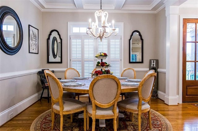 dining space with a chandelier, crown molding, wood finished floors, baseboards, and beam ceiling