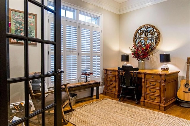 office area with ornamental molding and wood finished floors