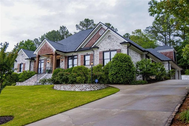 view of front of property with a front yard and brick siding