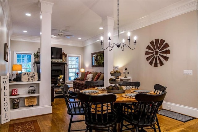 dining area with dark wood-type flooring, decorative columns, crown molding, ceiling fan, and recessed lighting