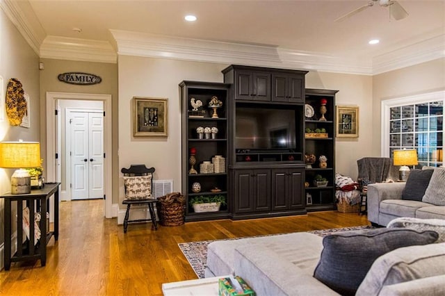 living area with wood finished floors, ceiling fan, ornamental molding, and recessed lighting