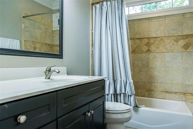 full bathroom featuring ornamental molding, toilet, vanity, and shower / bath combination with curtain