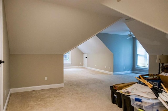 bonus room with carpet, vaulted ceiling, plenty of natural light, and ceiling fan