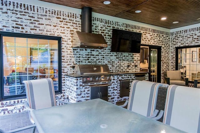 view of patio featuring outdoor dining space, area for grilling, and exterior kitchen