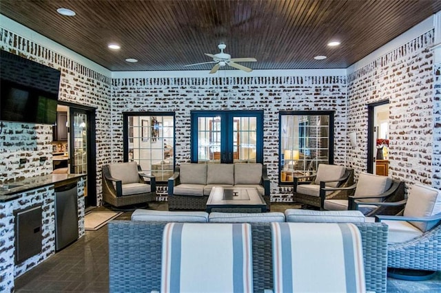 view of patio / terrace featuring a ceiling fan, an outdoor living space, and french doors
