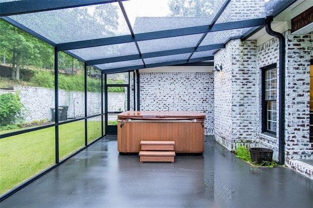 unfurnished sunroom featuring a hot tub
