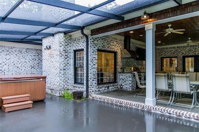 view of patio / terrace featuring a hot tub and a ceiling fan