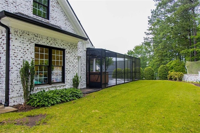view of green lawn with glass enclosure
