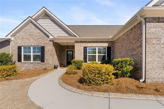 property entrance featuring brick siding