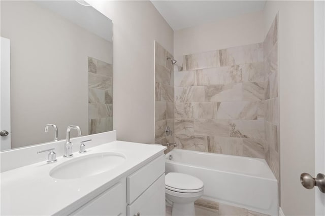 full bathroom with vanity, tiled shower / bath, and toilet