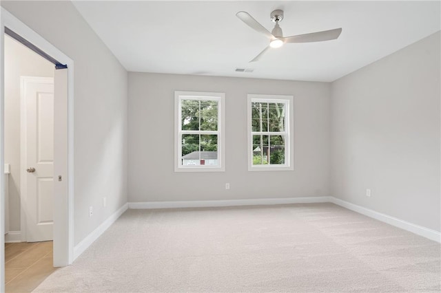 unfurnished room featuring ceiling fan and light colored carpet