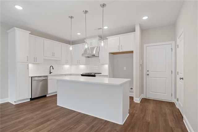 kitchen with tasteful backsplash, dark hardwood / wood-style flooring, appliances with stainless steel finishes, hanging light fixtures, and white cabinetry