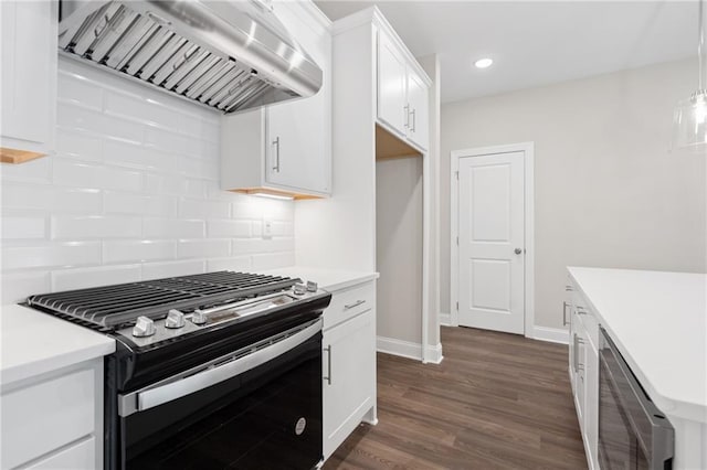 kitchen with white cabinetry, wall chimney exhaust hood, backsplash, dark hardwood / wood-style flooring, and stainless steel stove