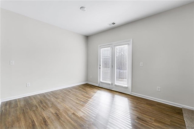 unfurnished room featuring hardwood / wood-style flooring