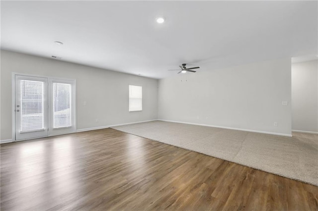 unfurnished room featuring hardwood / wood-style floors, a wealth of natural light, and ceiling fan