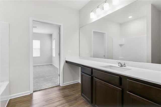 bathroom with vanity, hardwood / wood-style floors, and shower / bathtub combination