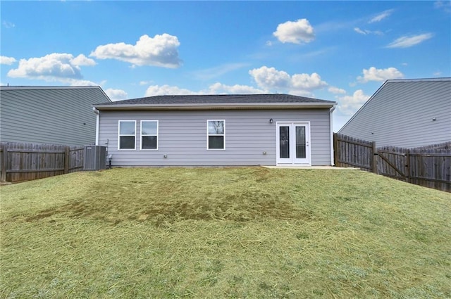 rear view of property with cooling unit, a lawn, and french doors