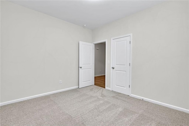 unfurnished bedroom with light colored carpet