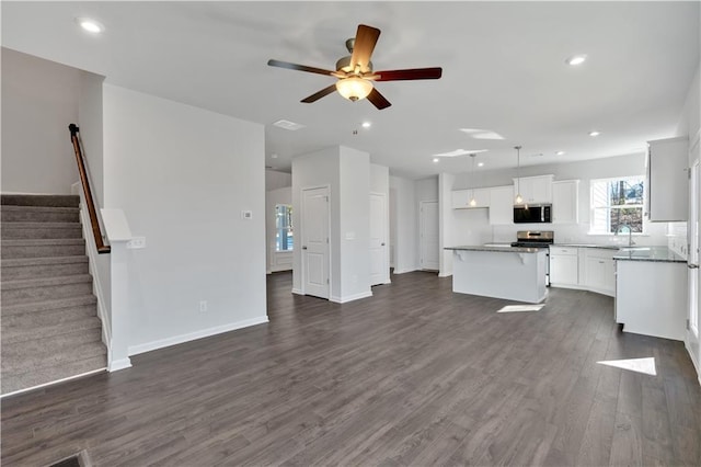 14 Grove Pointe Way SE, Cartersville, GA 30120 - unfurnished living room with baseboards, stairway, dark wood-style flooring, and recessed lighting