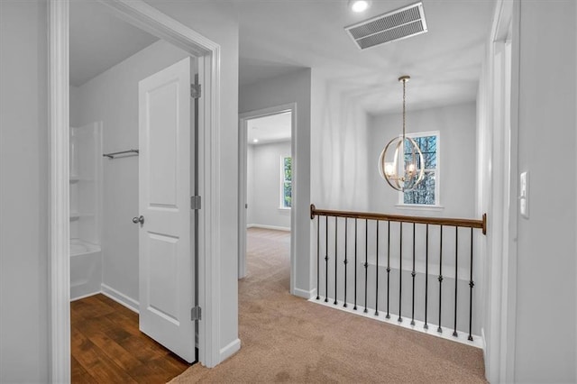 14 Grove Pointe Way SE, Cartersville, GA 30120 - hallway featuring baseboards, visible vents, dark carpet, and a chandelier