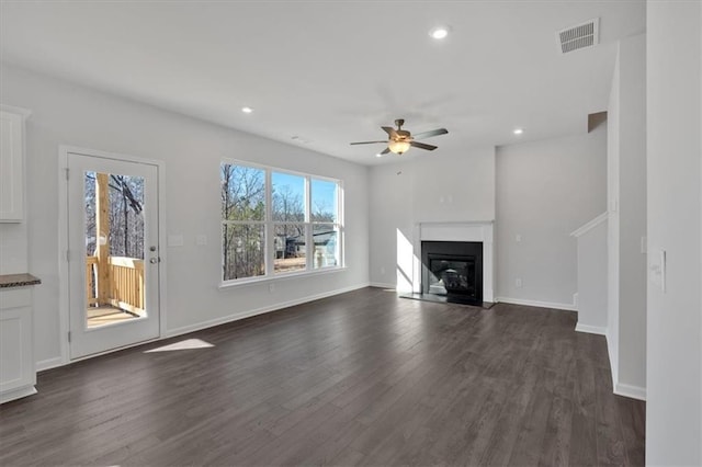 14 Grove Pointe Way SE, Cartersville, GA 30120 - unfurnished living room featuring recessed lighting, dark wood-style flooring, visible vents, baseboards, and a glass covered fireplace