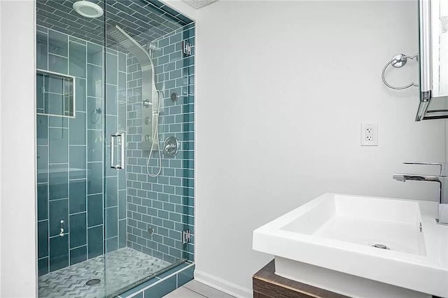 1202 Laurel Cliff Dr SE, Smyrna, GA 30082 - bathroom with a shower stall, a sink, tile patterned flooring, and baseboards