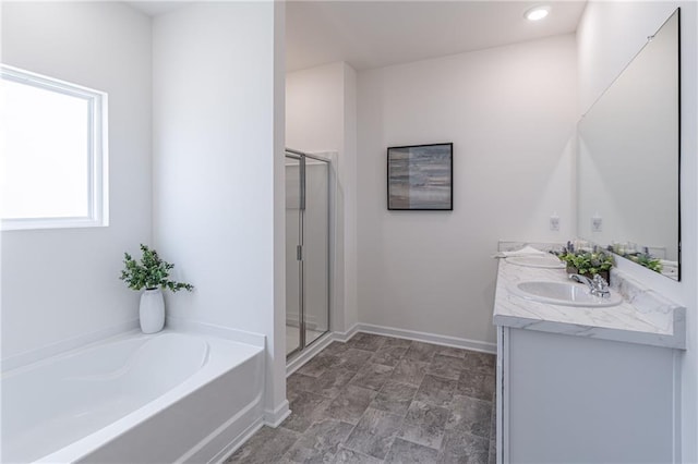 2010 Vidalia Ct, Dacula, GA 30019 - bathroom with a garden tub, a stall shower, double vanity, and baseboards