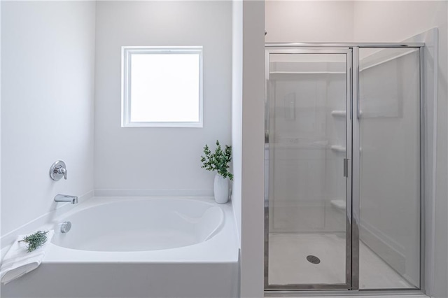 2010 Vidalia Ct, Dacula, GA 30019 - bathroom with a stall shower and a garden tub