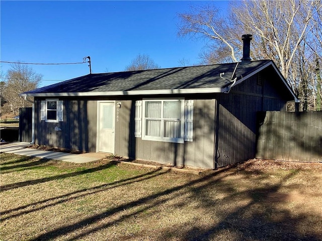 rear view of house with a yard