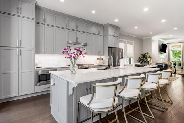 623 Brennan Dr, Decatur, GA 30033 - kitchen with appliances with stainless steel finishes, gray cabinetry, crown molding, under cabinet range hood, and a sink