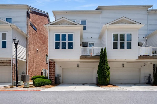 623 Brennan Dr, Decatur, GA 30033 - view of front of property featuring a garage, central air condition unit, concrete driveway, and a balcony