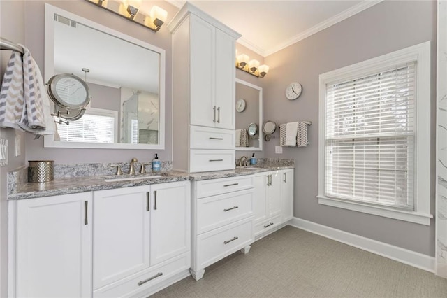 full bath with ornamental molding, double vanity, and baseboards
