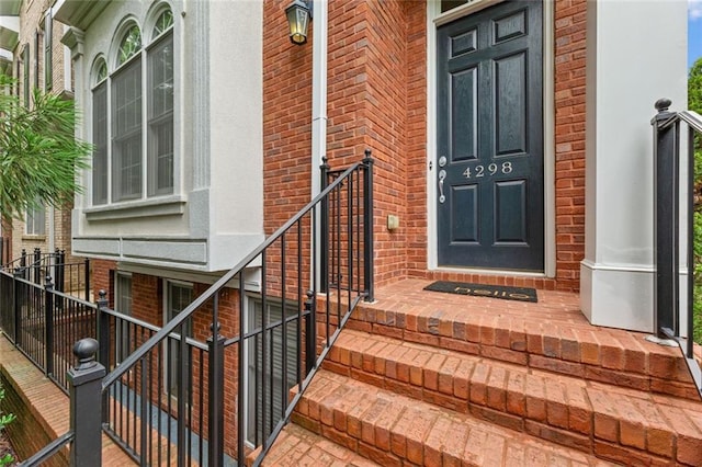 property entrance featuring brick siding