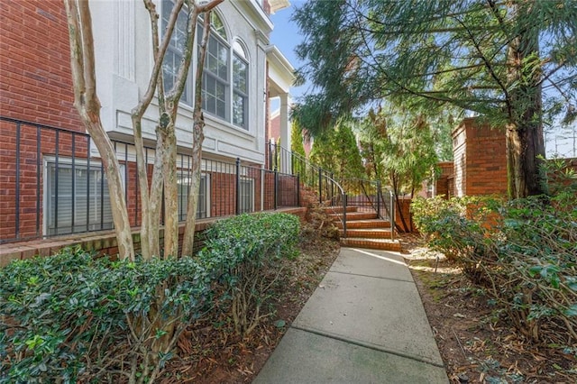 view of home's exterior with brick siding and stairway