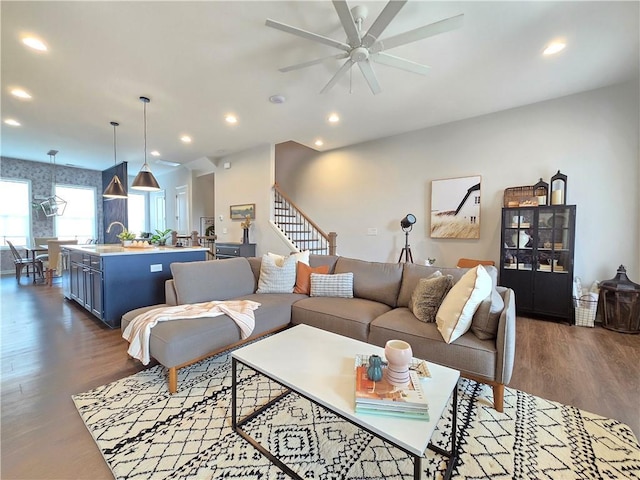 living room with dark wood-style floors, stairway, recessed lighting, and a ceiling fan