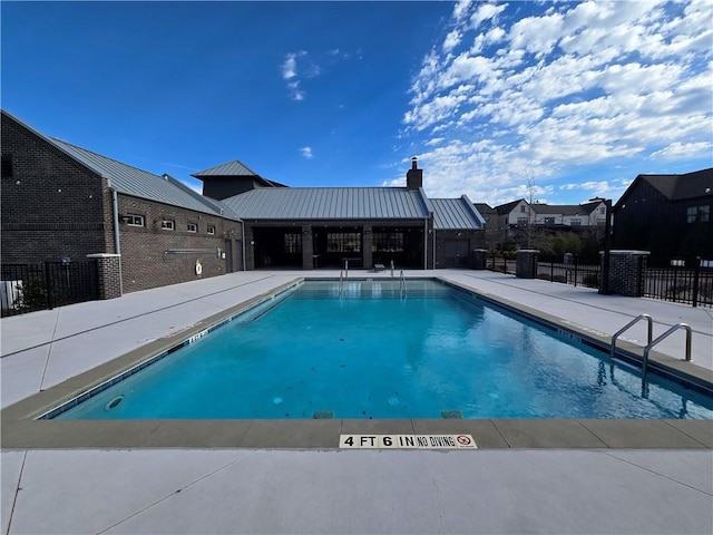 pool with fence and a patio