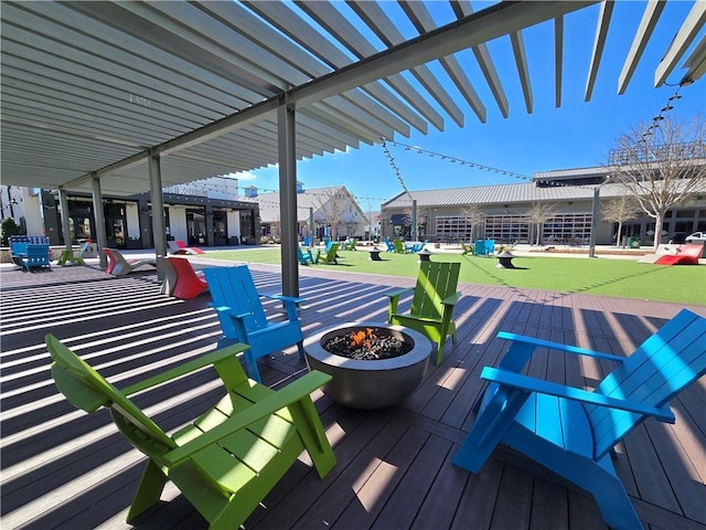 wooden deck featuring an outdoor fire pit