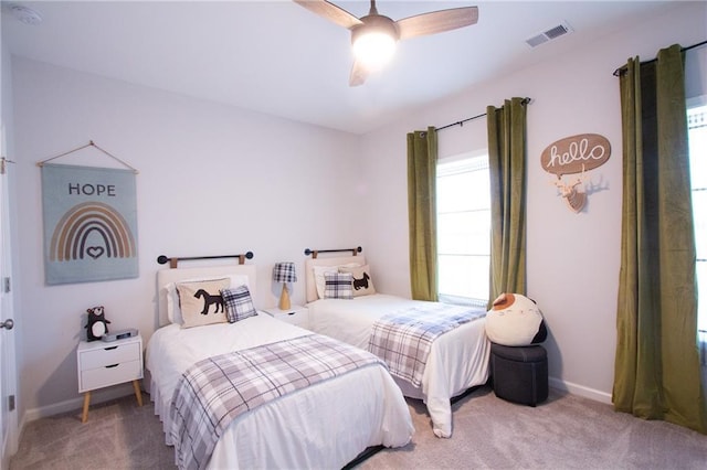 carpeted bedroom with ceiling fan, visible vents, and baseboards