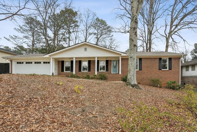 ranch-style house featuring a porch and a garage